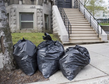 Workers loading rubbish at a terrace property in Addiscombe